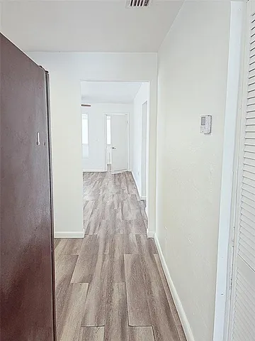 a view of a bedroom with wooden floor and staircase