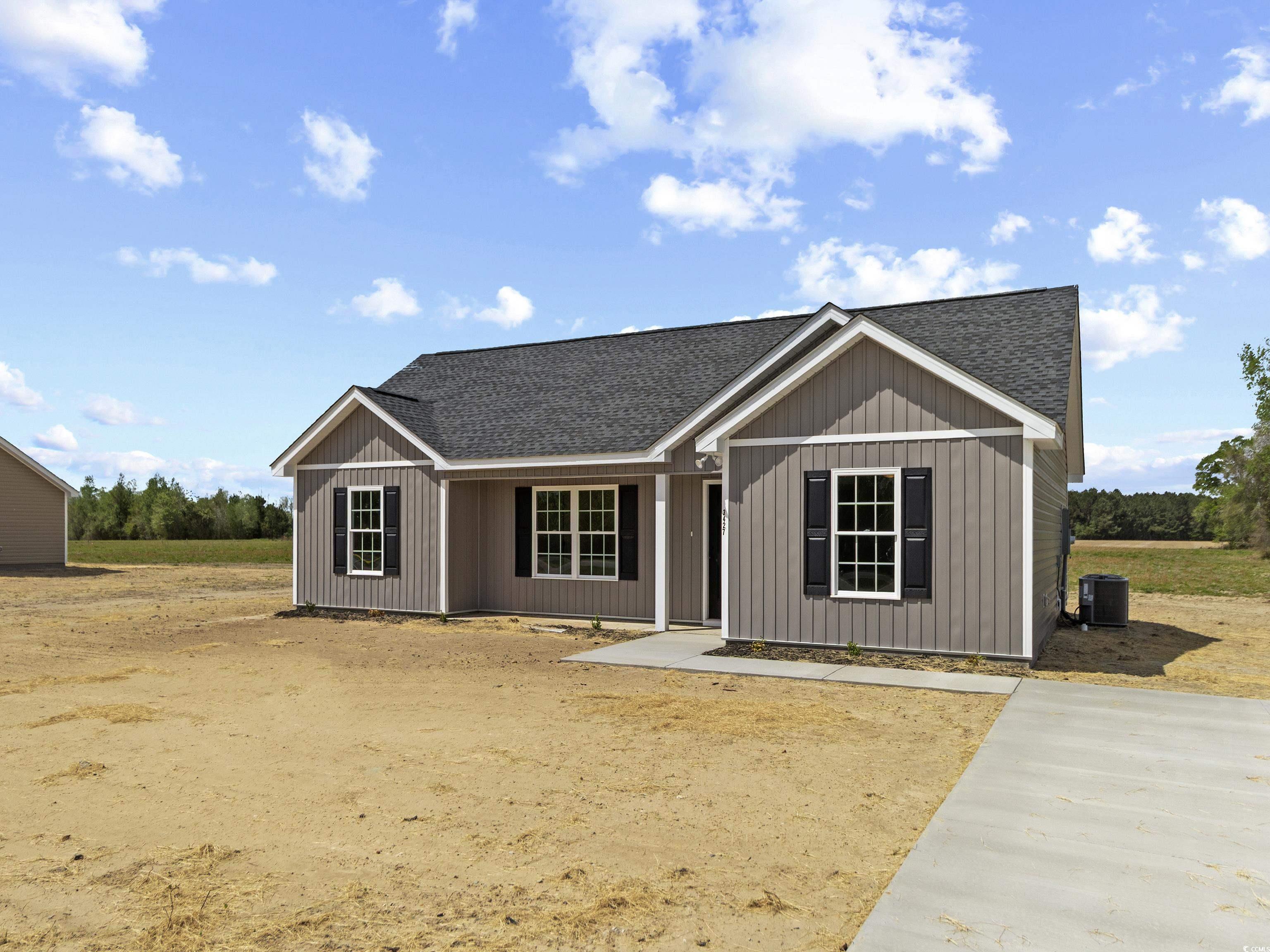 View of front of home with a shingled roof and central AC unit