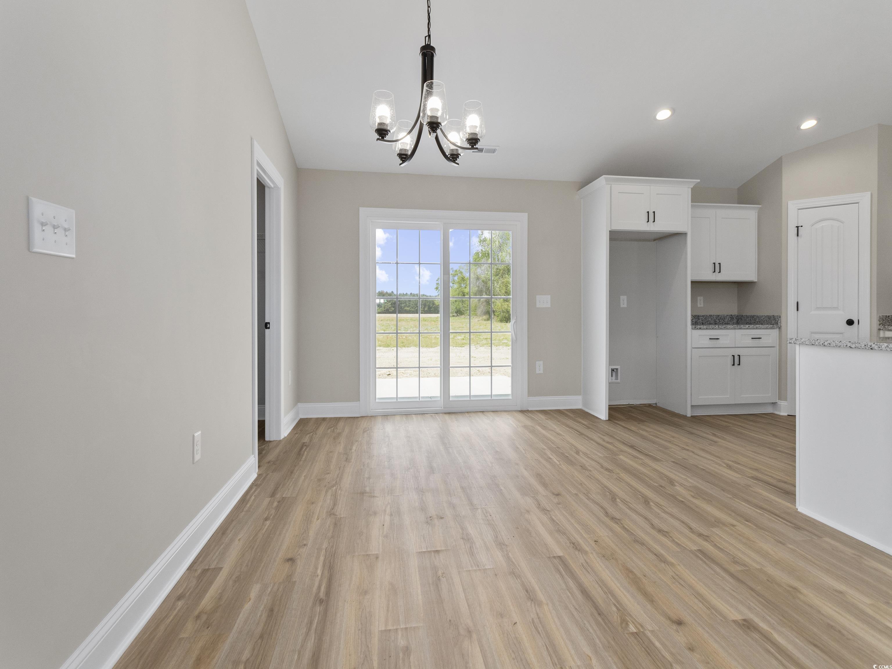 837 Highway 67 Loris Sc 29569 Loris, SC 29569 - Photo 17 of 31 Unfurnished dining area with light wood-type flooring, a notable chandelier, baseboards, and recessed lighting
