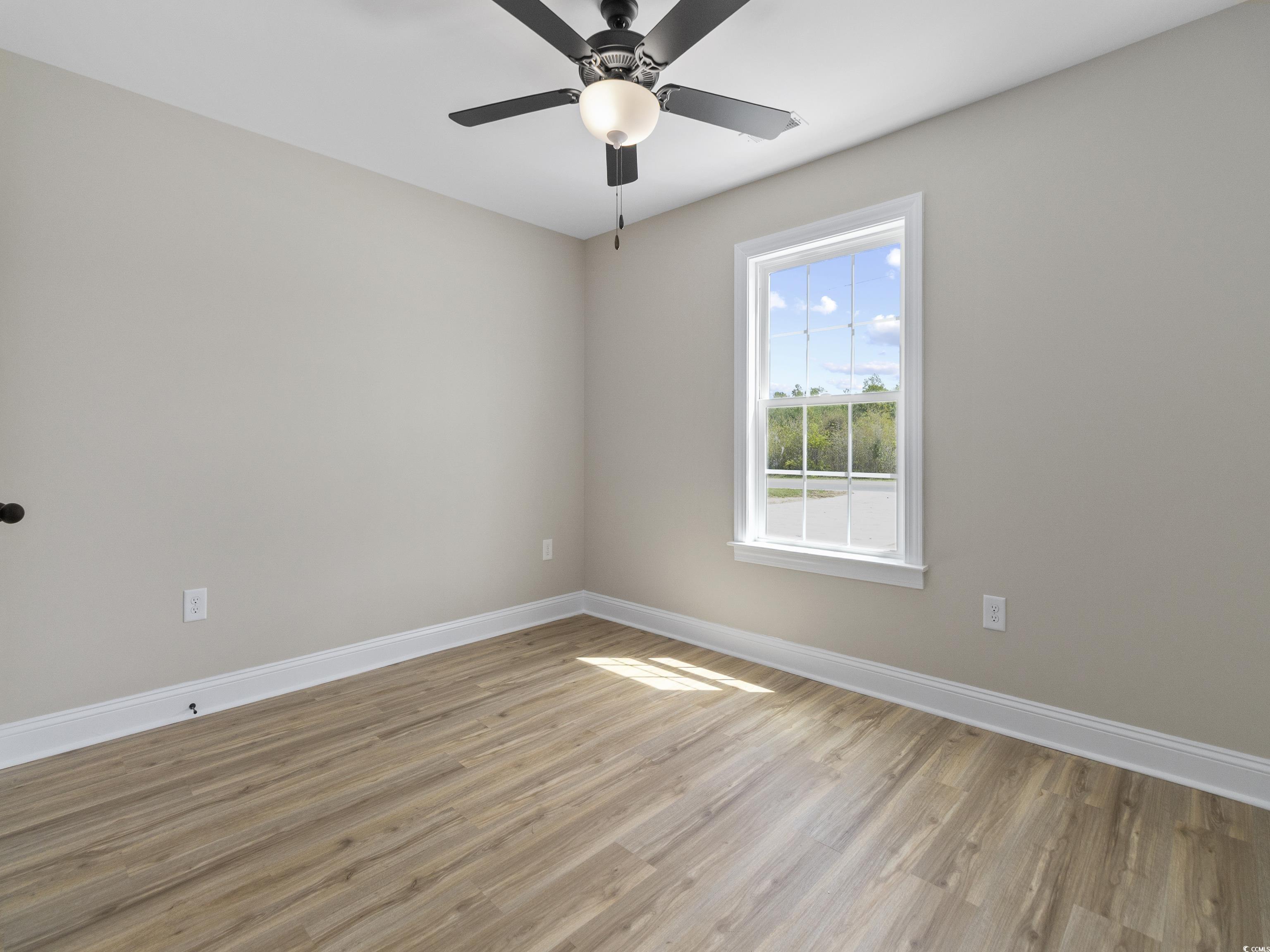 837 Highway 67 Loris Sc 29569 Loris, SC 29569 - Photo 27 of 31 Spare room featuring light wood finished floors, baseboards, and ceiling fan