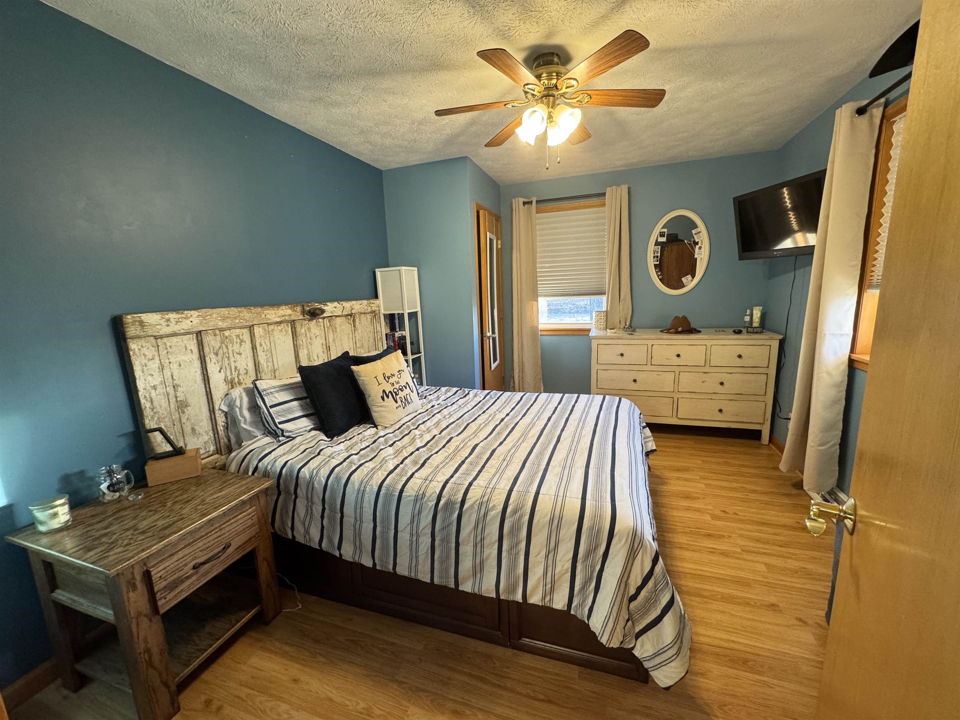 57 Herbert Road Kingston, IL 60145 - Photo 3 of 10 a bedroom with a bed and a chandelier
