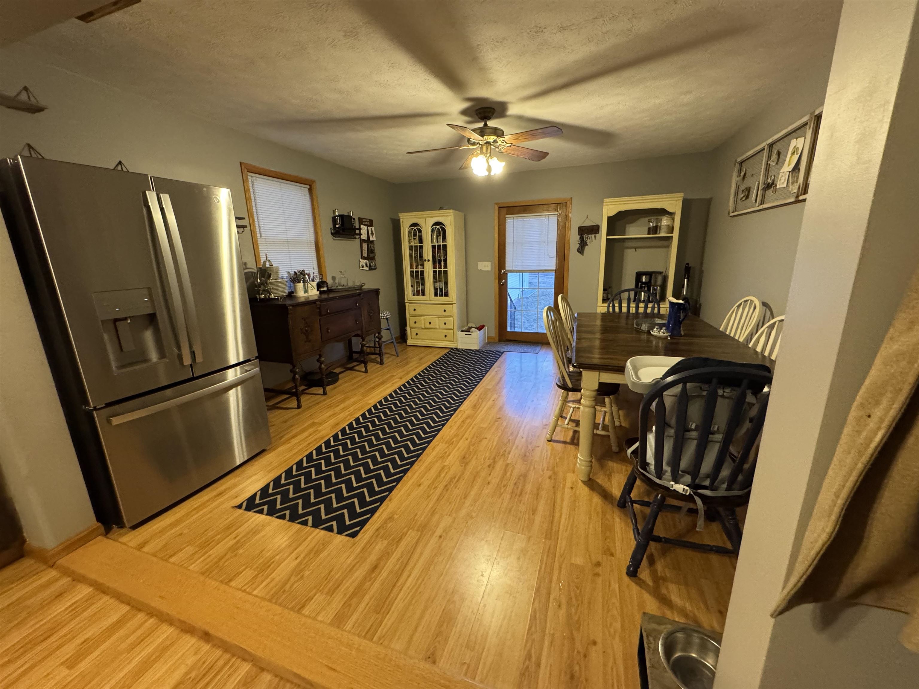 57 Herbert Road Kingston, IL 60145 - Photo 8 of 10 a view of a living room a dining room with furniture a rug and wooden floor