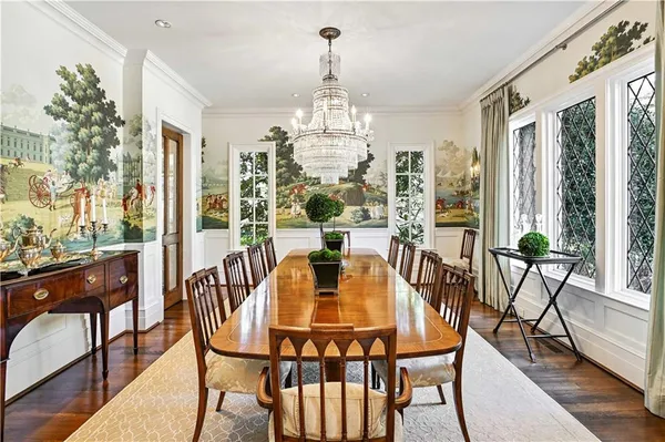 a view of a hallway with wooden floors and stairs