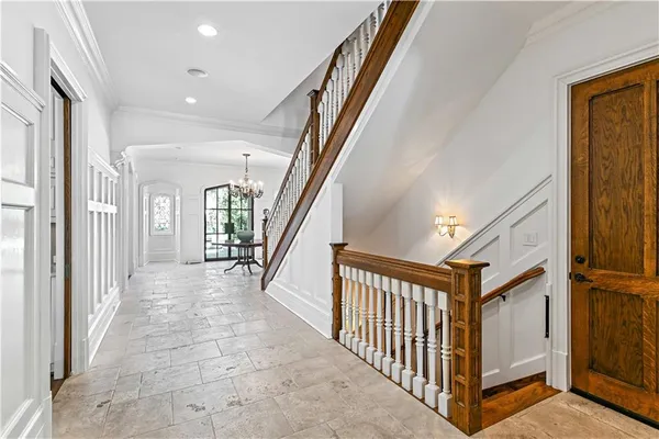 a large kitchen with kitchen island a stove a sink a refrigerator and white cabinets