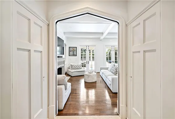 a living room with furniture a fireplace and a large mirror