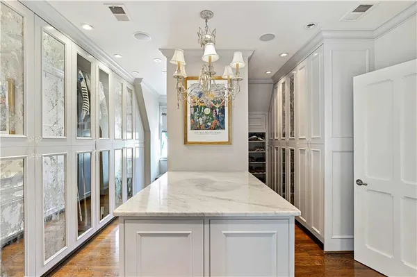 a kitchen with granite countertop white cabinets and stainless steel appliances