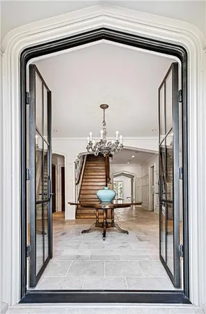 a view of a room with furniture and a chandelier