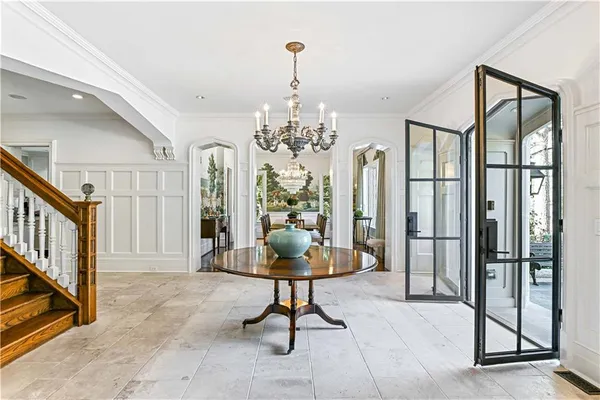 a living room with furniture fireplace and a large window