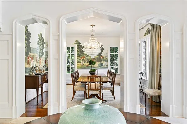 a view of staircase with lots of frames on wall and a view of entryway