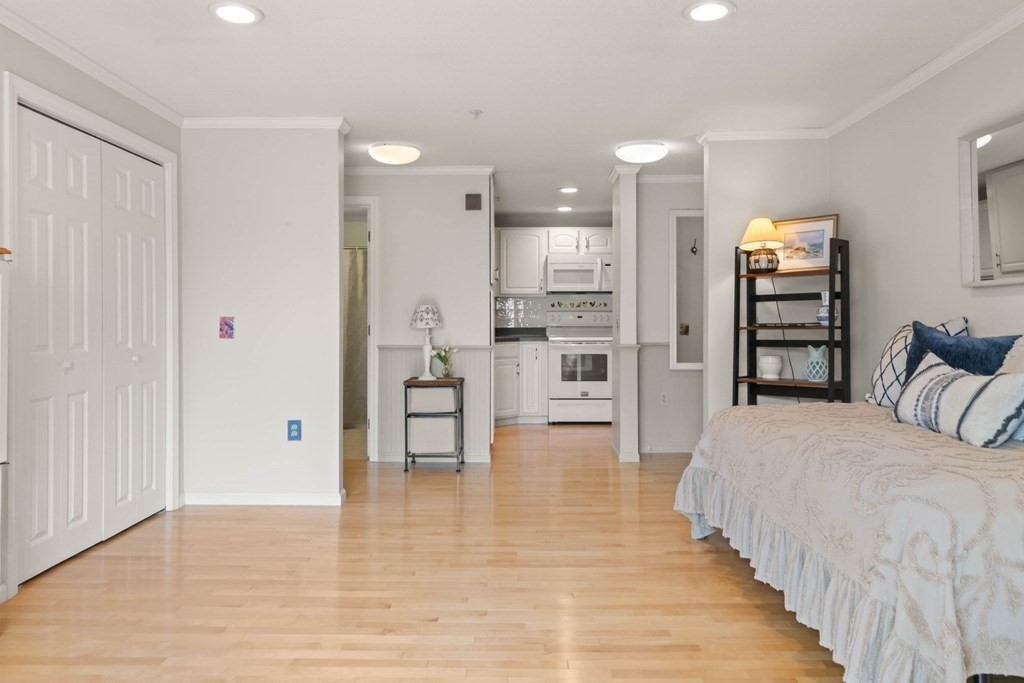 2 Ocean Avenue, Unit 3D Gloucester, MA 01930 - Photo 12 of 30 a large bedroom with a bed and a view of kitchen