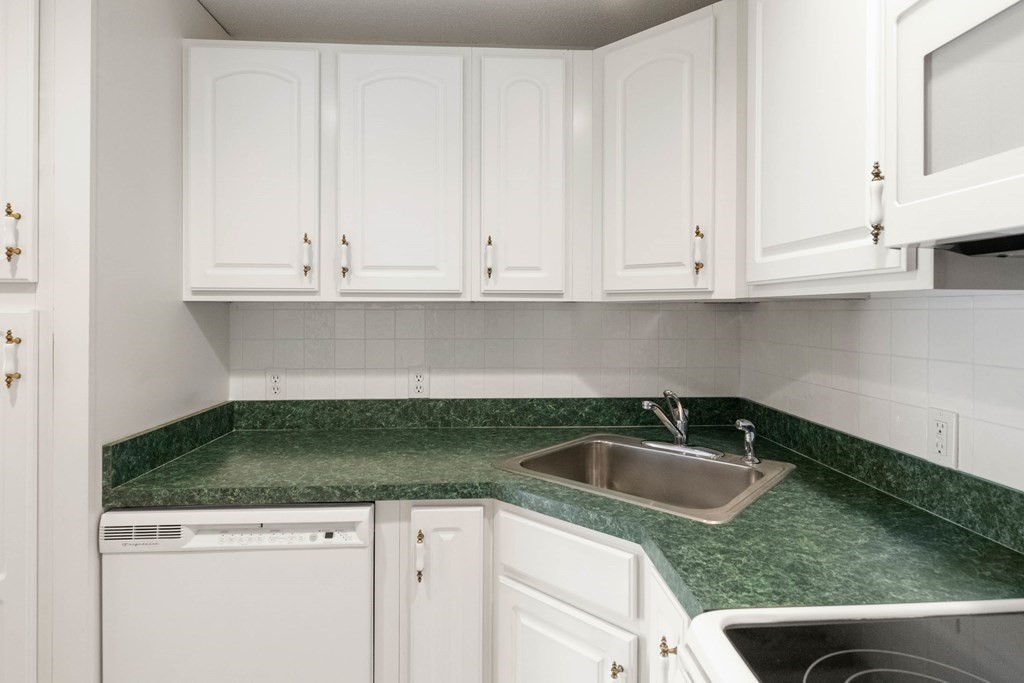 2 Ocean Avenue, Unit 3D Gloucester, MA 01930 - Photo 16 of 30 a kitchen with granite countertop white cabinets and sink