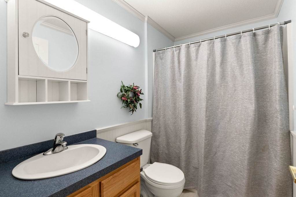 2 Ocean Avenue, Unit 3D Gloucester, MA 01930 - Photo 18 of 30 a bathroom with a toilet a sink and a mirror