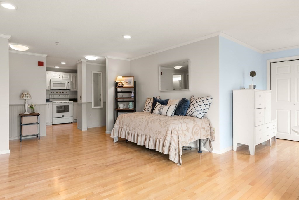 2 Ocean Avenue, Unit 3D Gloucester, MA 01930 - Photo 9 of 30 a spacious bedroom with a bed and a view of cabinet