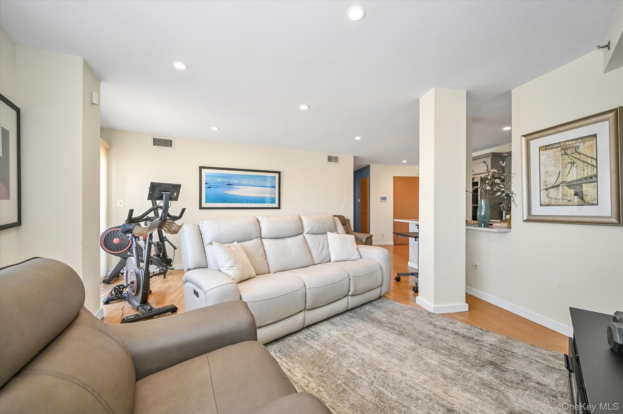 81-14 Queens Boulevard, Unit PH6C Queens, NY 11373 - Photo 4 of 19 Living area with recessed lighting and light wood-style flooring