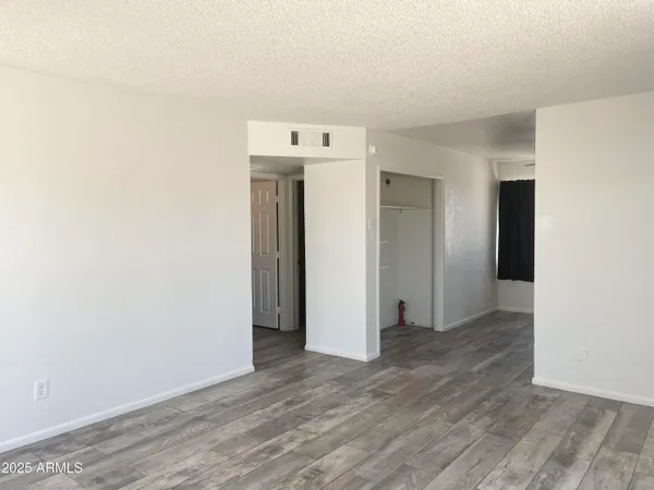 a view of a room with wooden floor
