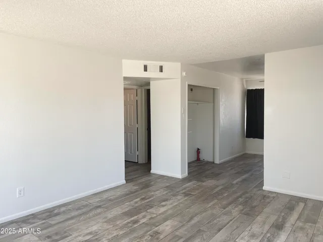 a view of a room with wooden floor