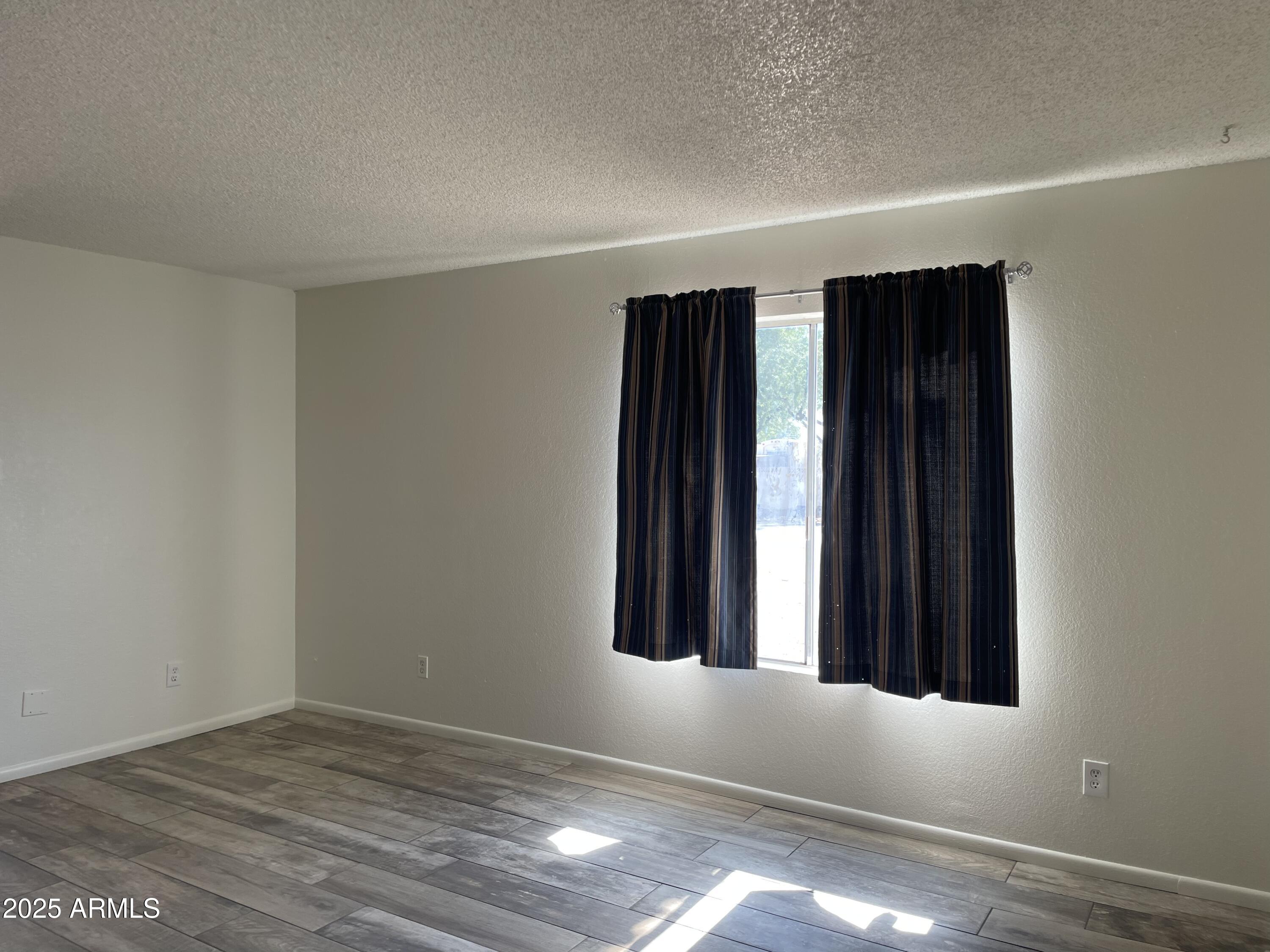 143 South Mountain Road, Unit 1 Apache Junction, AZ 85120 - Photo 10 of 17 an empty room with windows