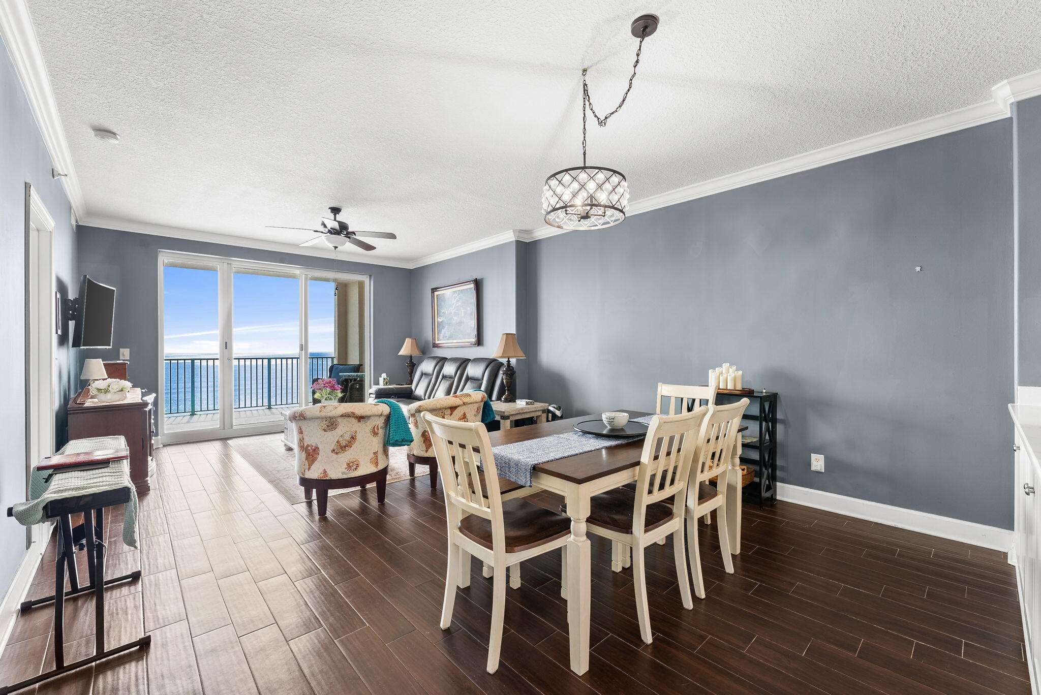 14415 Front Beach Road, Unit 1305 Panama City Beach, FL 32413 - Photo 14 of 47 a view of a dining room with furniture wooden floor and chandelier