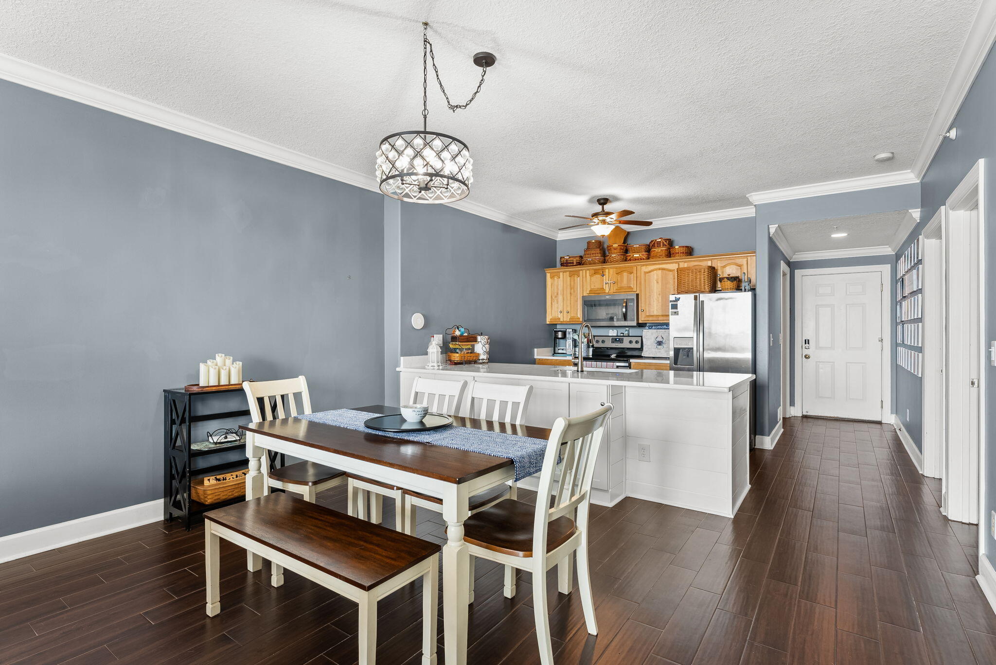 14415 Front Beach Road, Unit 1305 Panama City Beach, FL 32413 - Photo 15 of 47 a view of a dining room with furniture wooden floor and chandelier