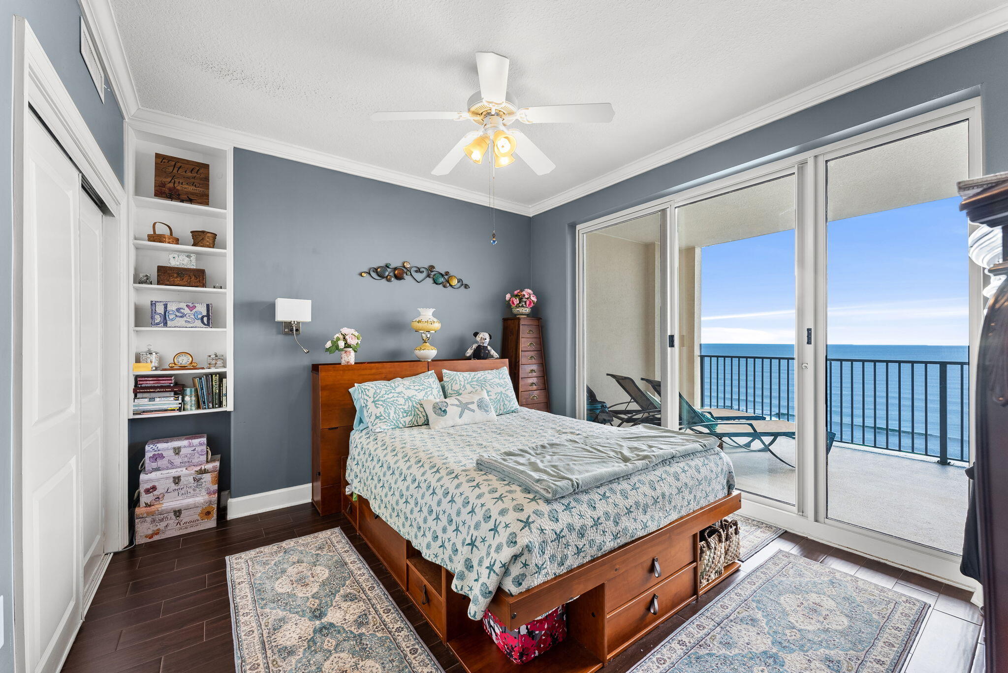 14415 Front Beach Road, Unit 1305 Panama City Beach, FL 32413 - Photo 17 of 47 a bedroom with a large bed and a chandelier