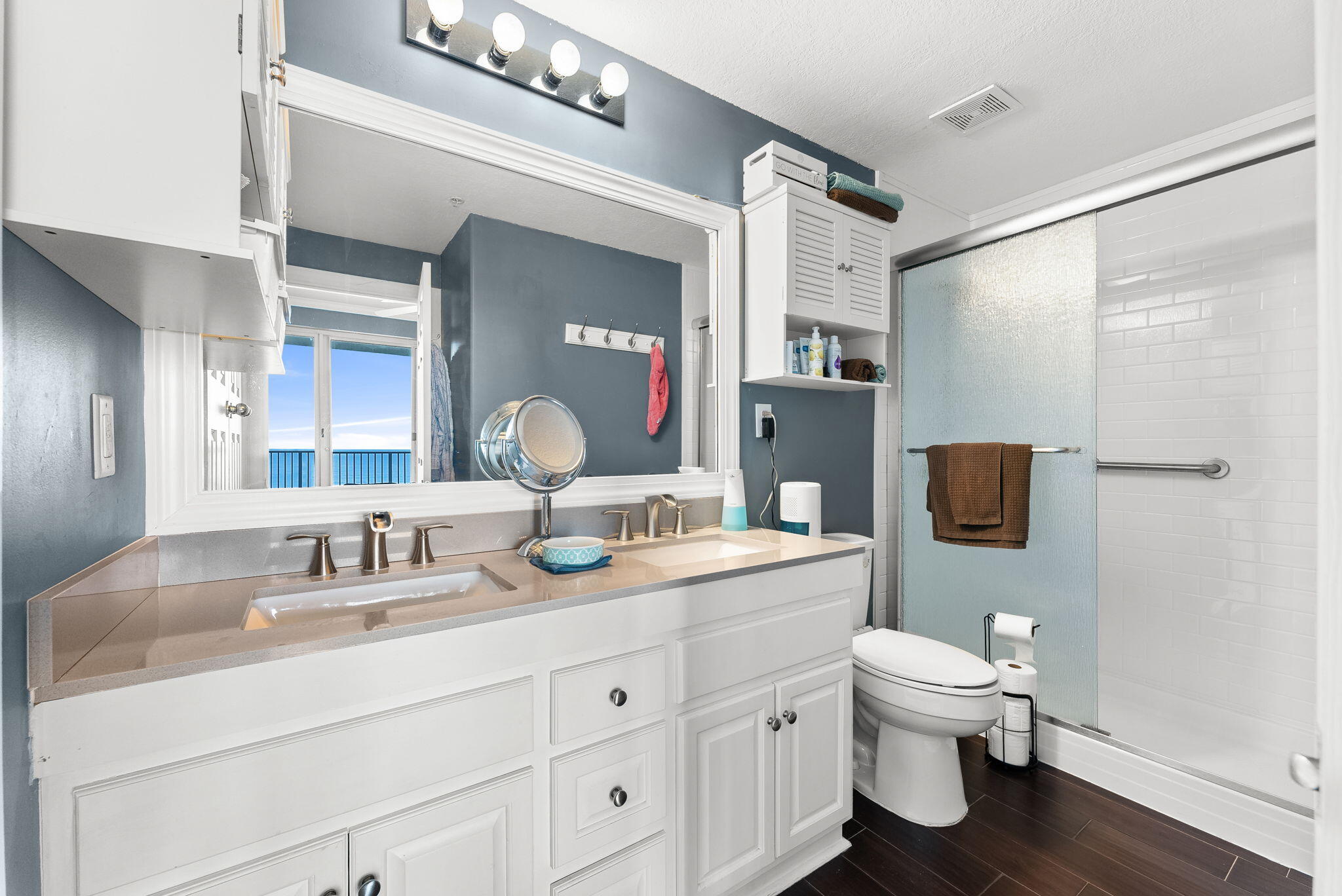 14415 Front Beach Road, Unit 1305 Panama City Beach, FL 32413 - Photo 19 of 47 a bathroom with a toilet sink double vanity and mirror