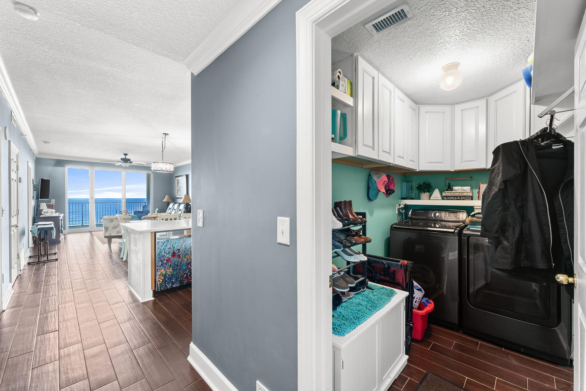 14415 Front Beach Road, Unit 1305 Panama City Beach, FL 32413 - Photo 23 of 47 a kitchen with refrigerator and cabinets