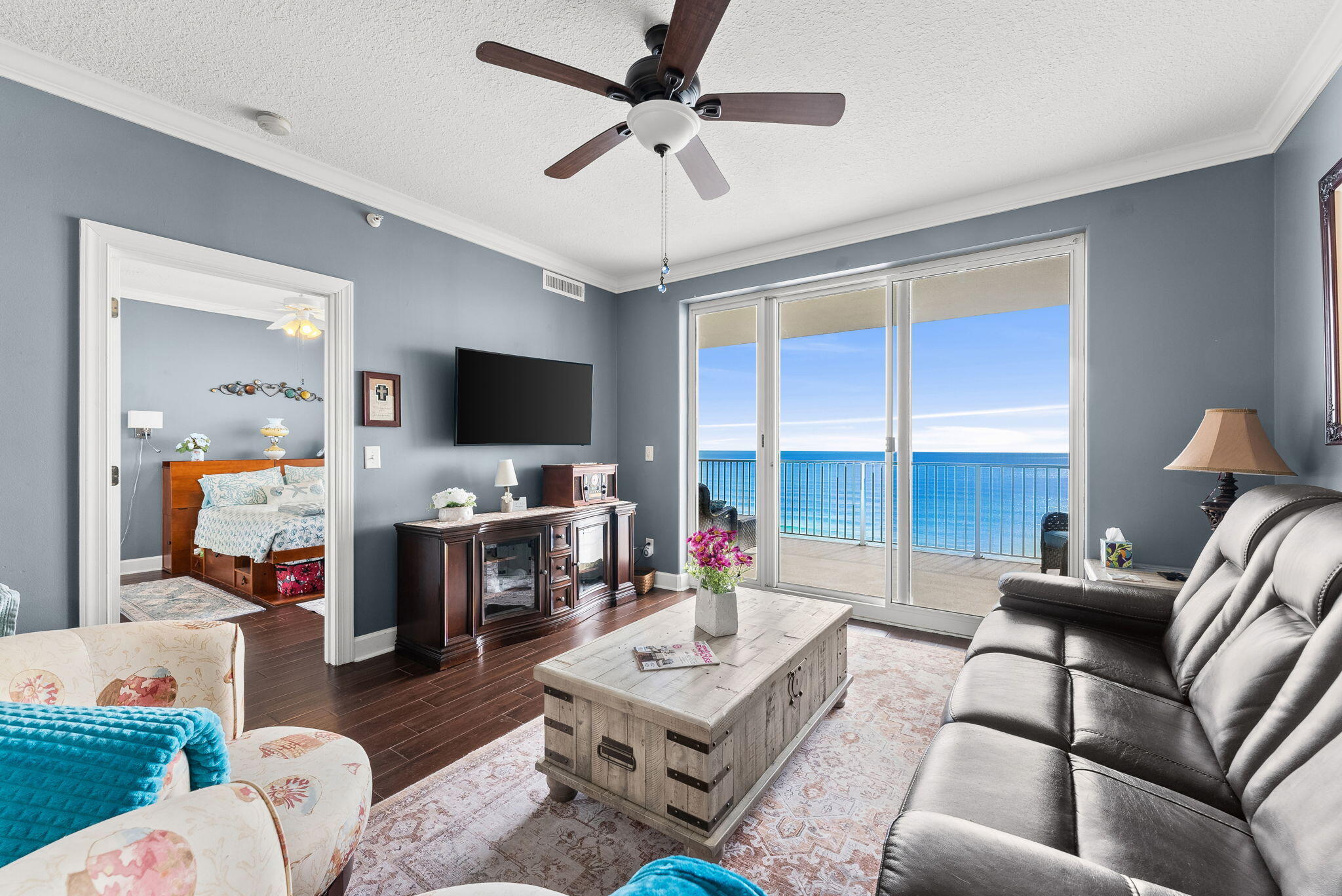 14415 Front Beach Road, Unit 1305 Panama City Beach, FL 32413 - Photo 5 of 47 a living room with furniture a flat screen tv and a large window