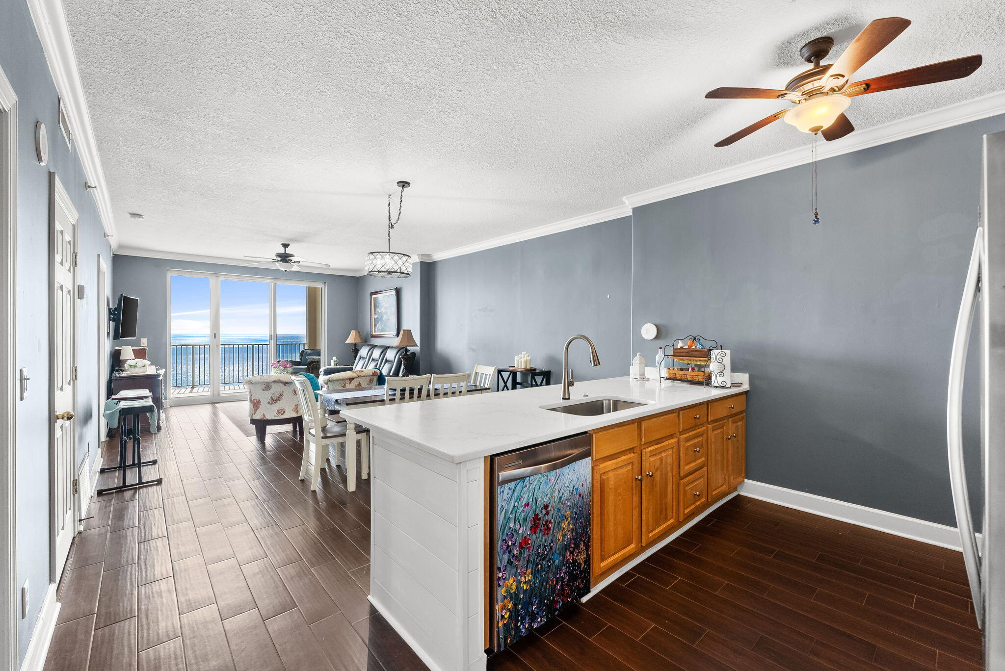 14415 Front Beach Road, Unit 1305 Panama City Beach, FL 32413 - Photo 10 of 47 a kitchen with a sink and wooden floor