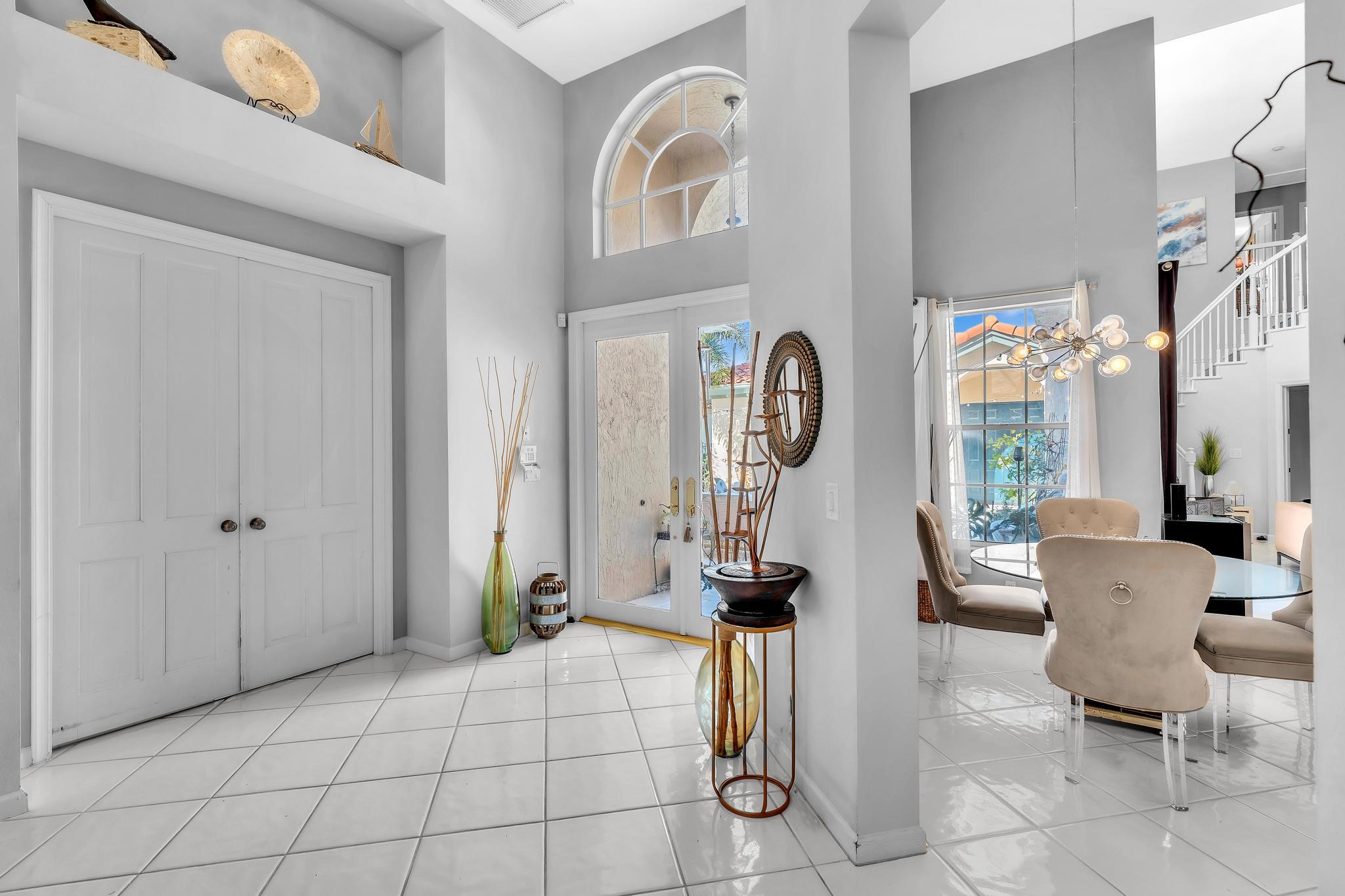 6230 Northwest 23rd Street Boca Raton, FL 33434 - Photo 15 of 90 a view of living room filled with furniture and floor to ceiling window