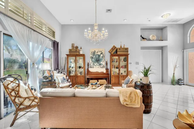 a kitchen that has a sink and chairs in it