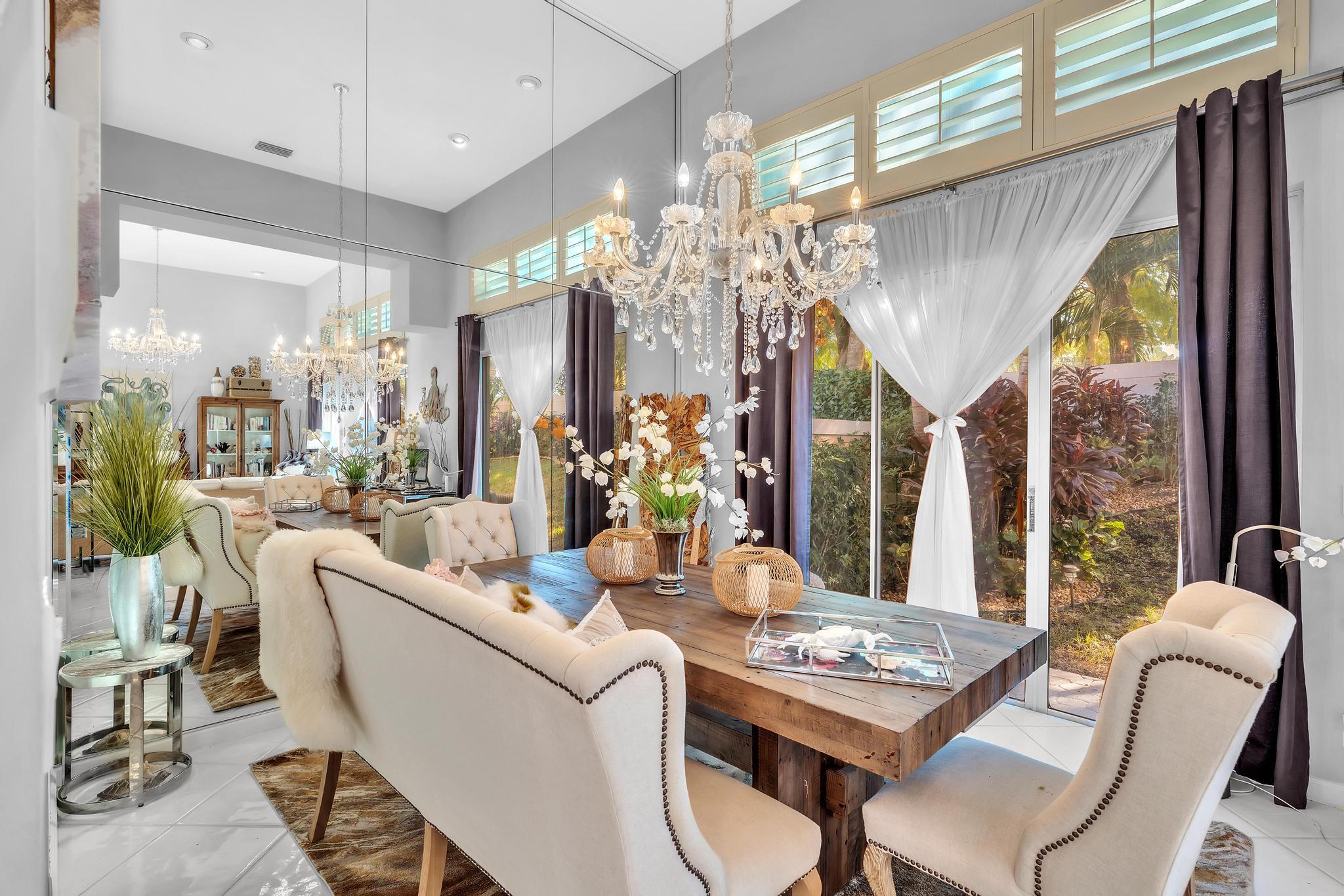 6230 Northwest 23rd Street Boca Raton, FL 33434 - Photo 18 of 90 a dining room with furniture a chandelier and wooden floor