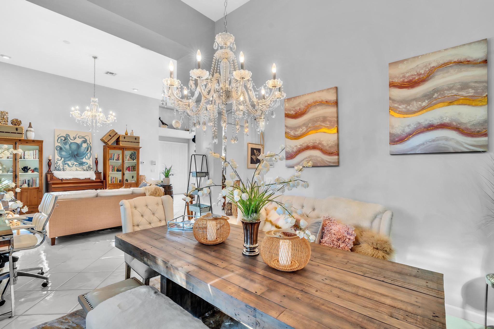 6230 Northwest 23rd Street Boca Raton, FL 33434 - Photo 19 of 90 a dining room with furniture a chandelier and wooden floor
