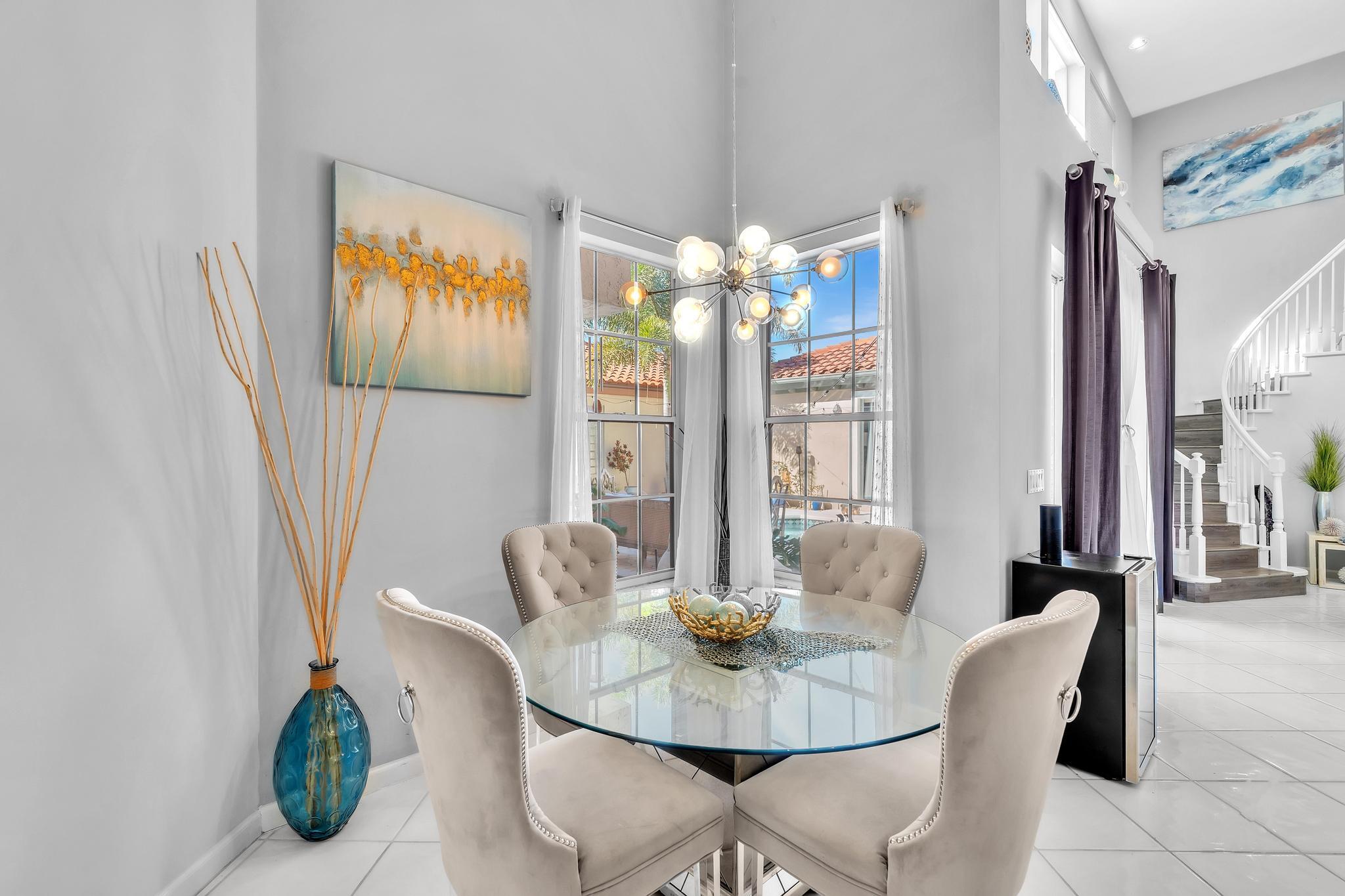 6230 Northwest 23rd Street Boca Raton, FL 33434 - Photo 22 of 90 a dining room with furniture and chandelier
