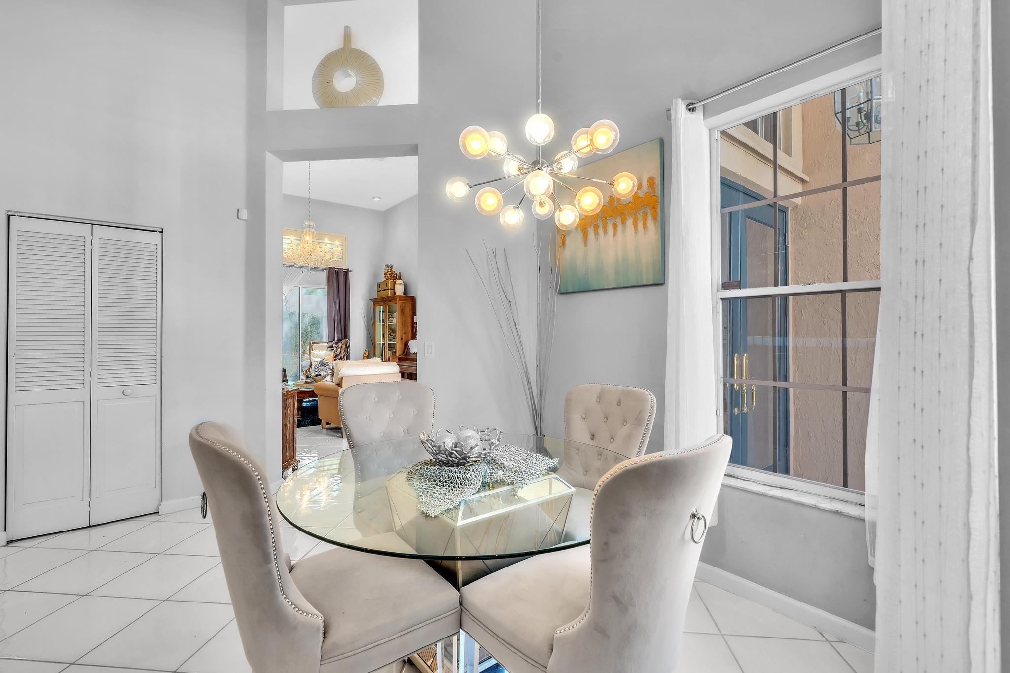 6230 Northwest 23rd Street Boca Raton, FL 33434 - Photo 23 of 90 a dining room with furniture and chandelier