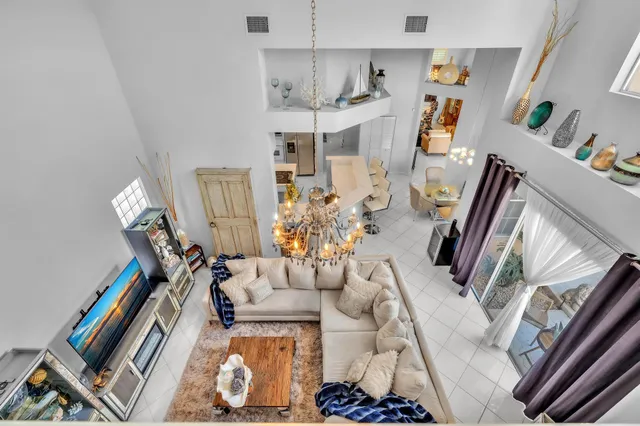 a view of a patio with a table and chairs under an umbrella