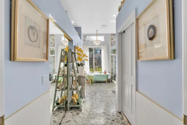 a view of a patio with a table and chairs under an umbrella