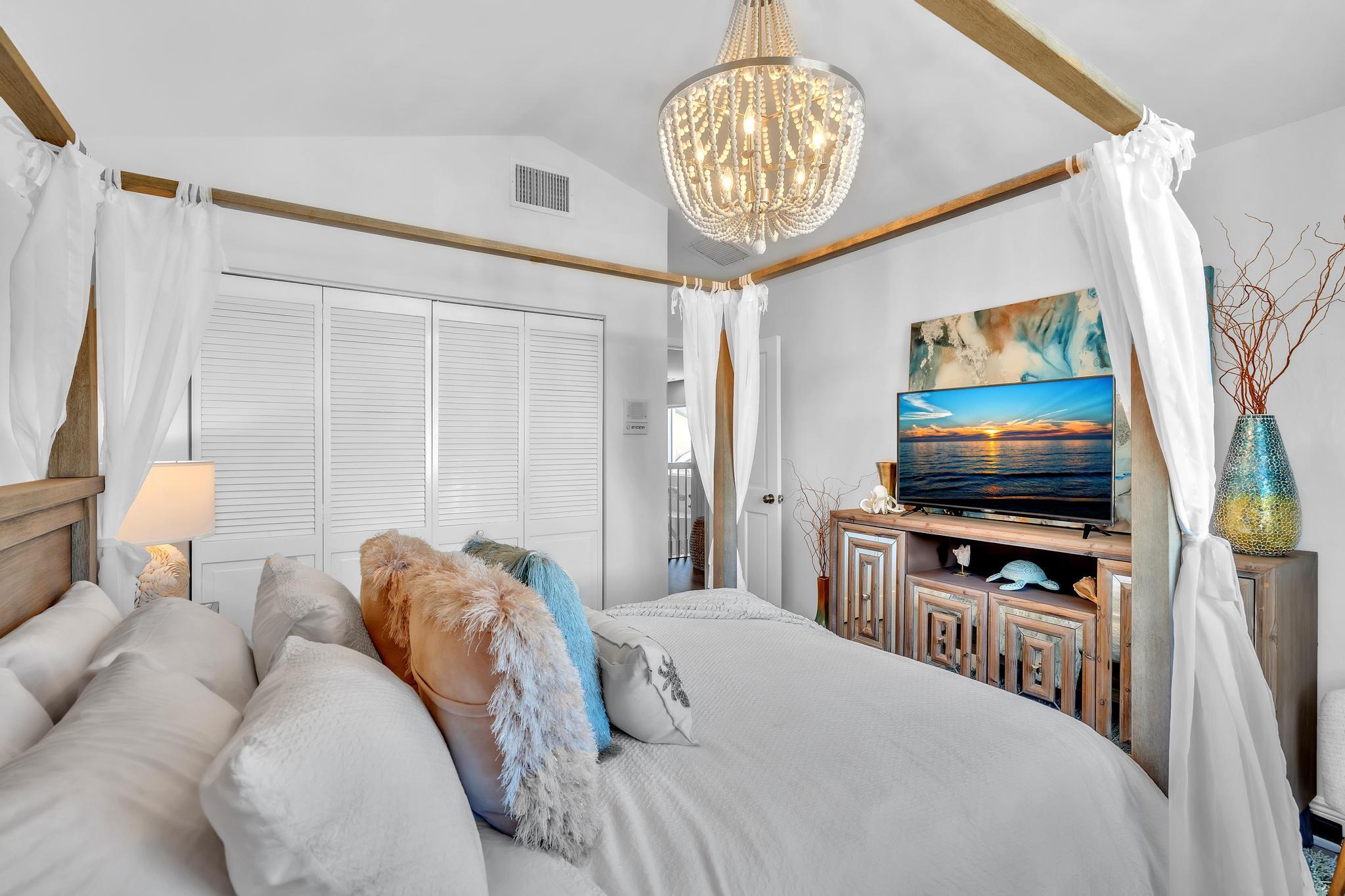 6230 Northwest 23rd Street Boca Raton, FL 33434 - Photo 47 of 90 a bedroom with a bed and a chandelier