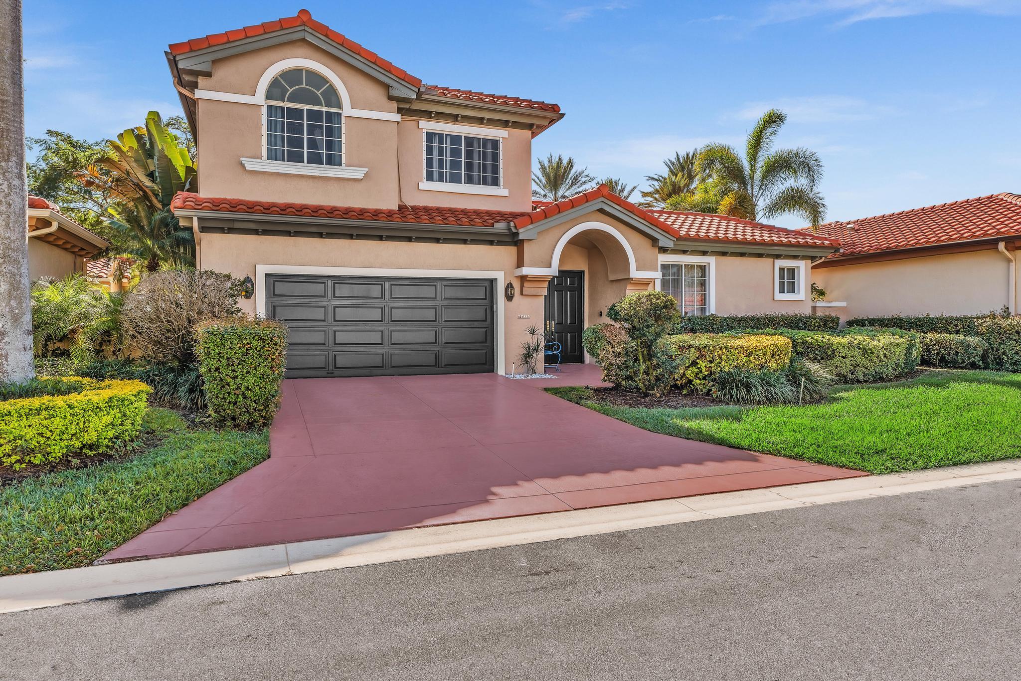 6230 Northwest 23rd Street Boca Raton, FL 33434 - Photo 5 of 90 a front view of a house with a yard and garage