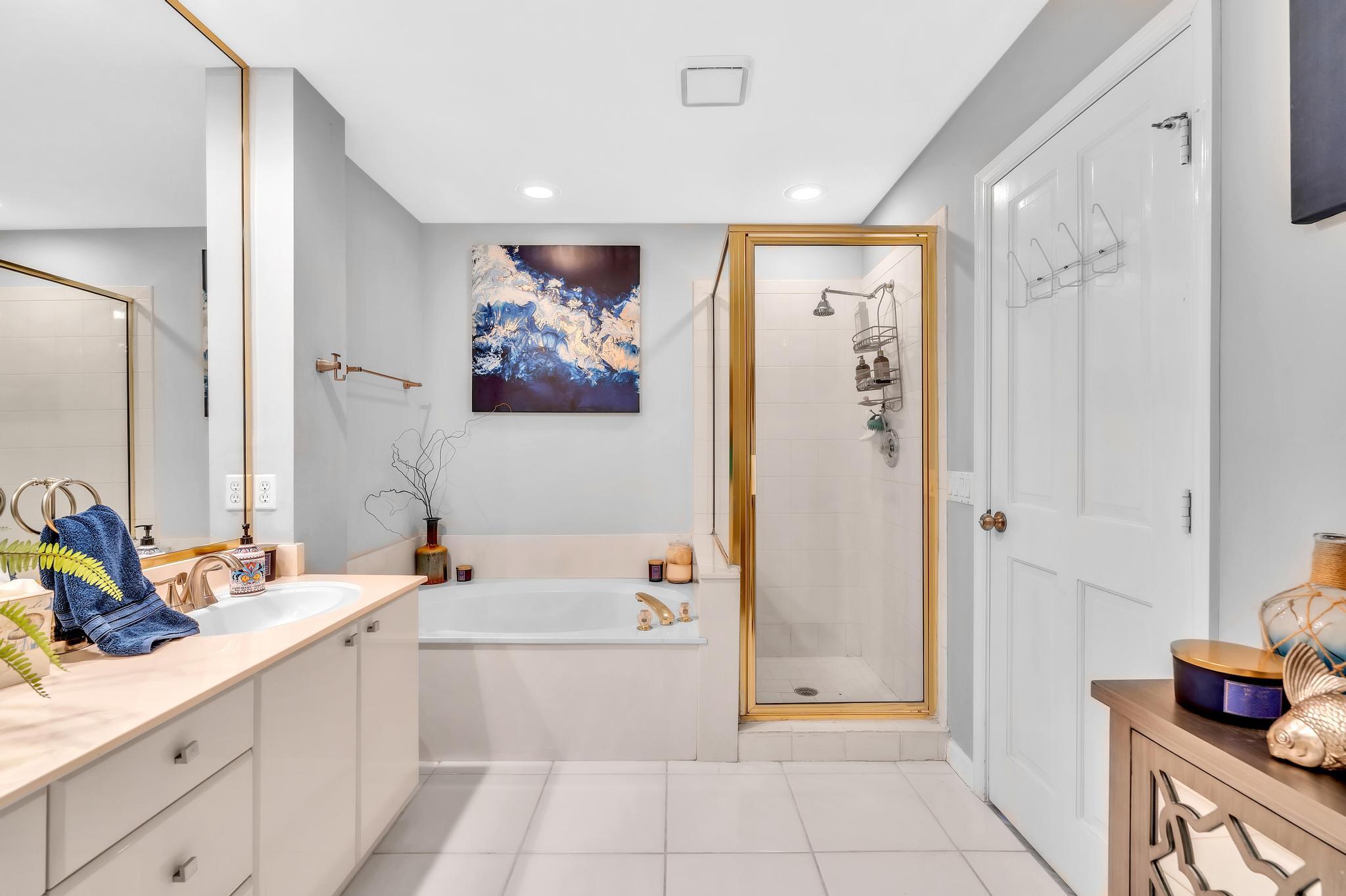 6230 Northwest 23rd Street Boca Raton, FL 33434 - Photo 51 of 90 a bathroom with a tub sink and mirror