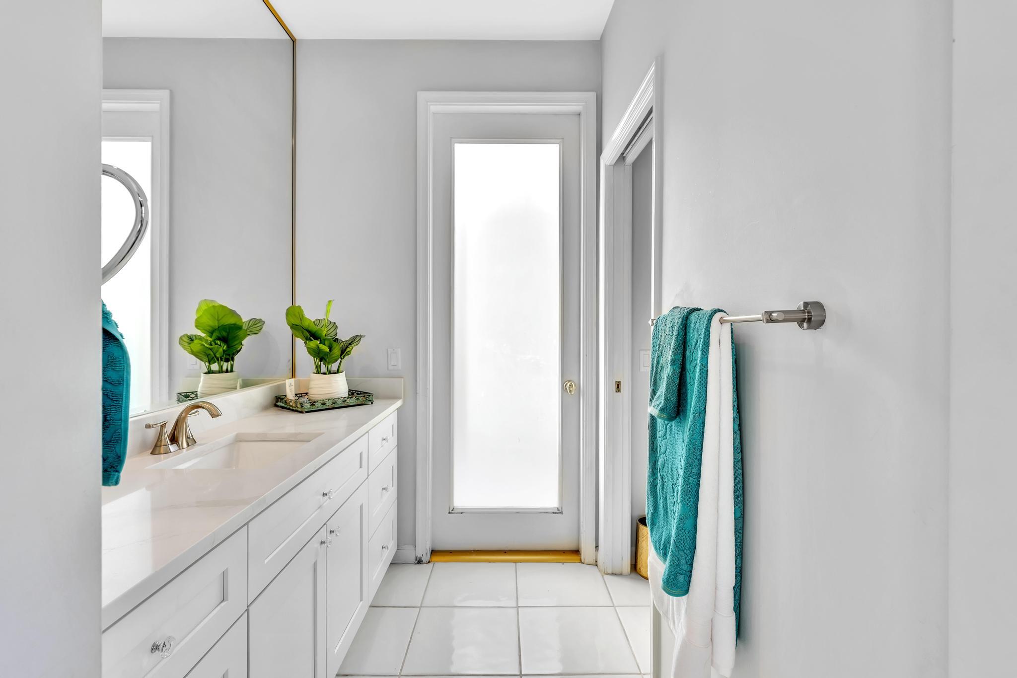 6230 Northwest 23rd Street Boca Raton, FL 33434 - Photo 54 of 90 a bathroom with a double vanity sink and a mirror