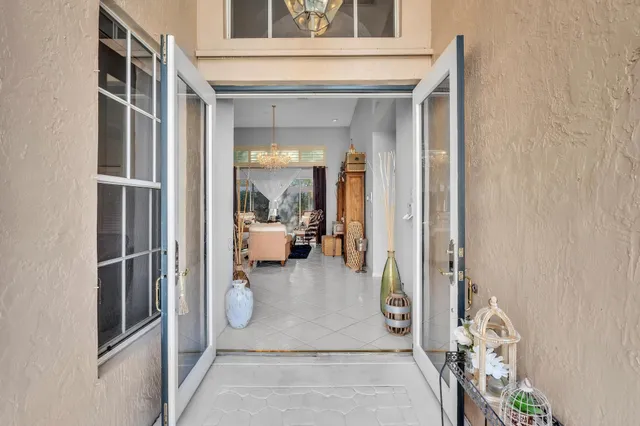 a dining room with furniture a chandelier and wooden floor