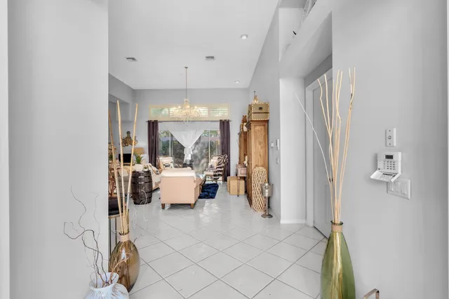a dining room with furniture a chandelier and wooden floor