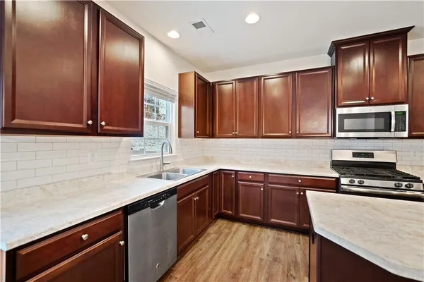 a kitchen with a sink stove and microwave