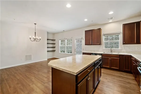 a kitchen with a stove a sink and a refrigerator