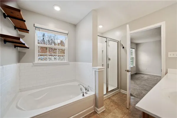 a bathroom with a bathtub and a shower