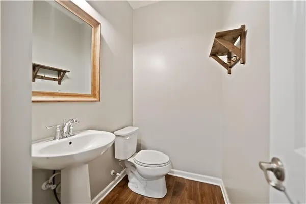 a bathroom with a toilet a sink and mirror