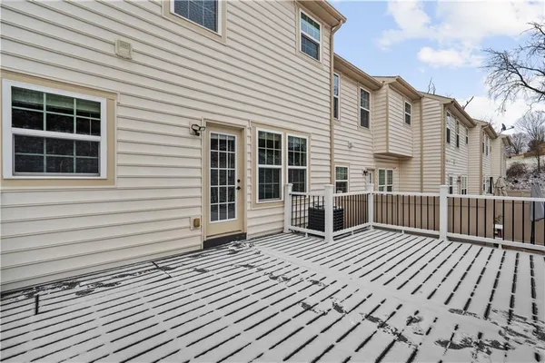 a view of a house with wooden deck
