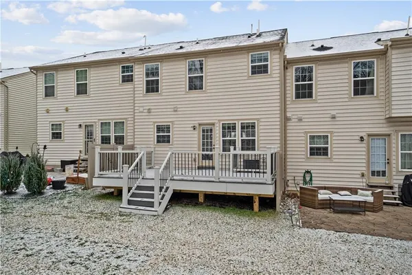 a view of a house with a yard and wooden fence