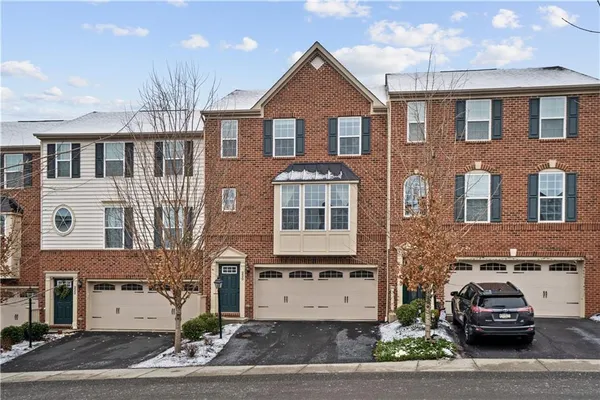 a front view of a residential apartment building with a yard