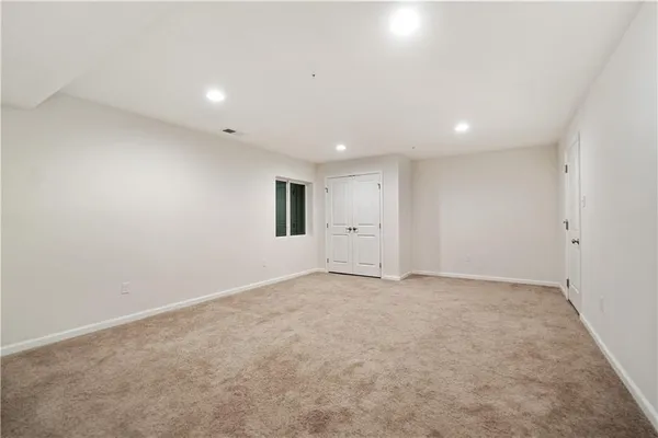 an empty room with a empty space and windows